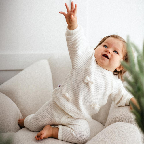 Fluffy Tails Eevi- ecru detský dievčenský sveter s mašľami a rebrovaním